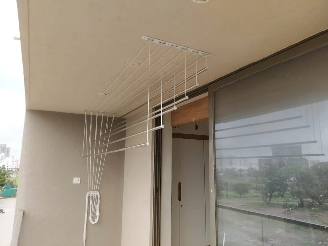 Ceiling mounted cloth hanger with multiple drying rods in a modern home